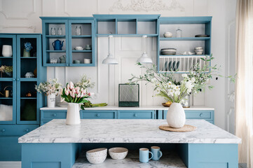 Marble countertop with vases and flowers in vintage kitchen