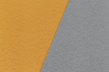 Fototapeta na wymiar Texture of craft dark orange and gray paper background, half two colors, macro. Vintage kraft ocher and grey cardboard.