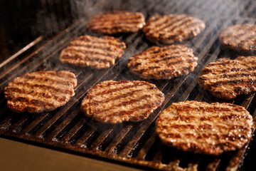 Hamburger beef cutlets grilled on the flame.