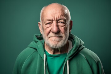 Headshot portrait photography of a satisfied old man wearing a cozy zip-up hoodie against a pastel green background. With generative AI technology