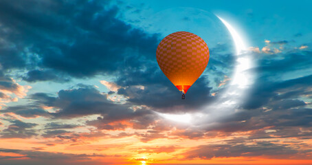 Hot air balloon flying over tropic sea with crescent moon at amazing sunset