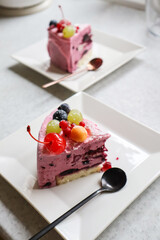 The piece of fruit cake with berries on a white plate.