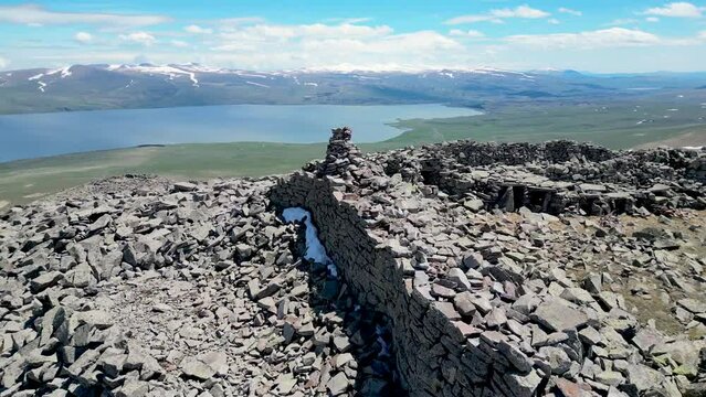 Ruins of a bronze-age fortress on a mountaintop in the Caucasus mountains