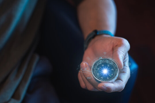 entrepreneur holding a compass in his hand. Define your marketing strategy and look for global customer networks.