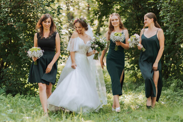A bride celebrates her wedding with friends outdoors after the ceremony - obrazy, fototapety, plakaty