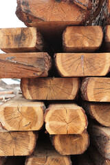 Stacks with pine lumber. Wooden boards are stacked. Woodworking industry.Folded edged board. Harvesting of wood. Vertical photo.