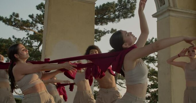 Professional dancing group performing an interpretive dance in a temple, 4k