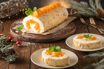 Meringue roll cake with cream, tangerine.