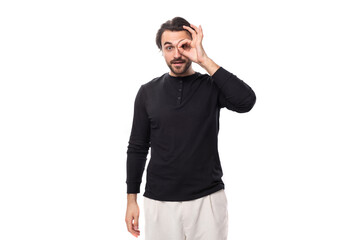 Fototapeta premium close-up portrait of a bearded well-groomed brunette with a chic stylish hairstyle in a black jacket on a white background