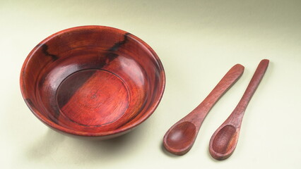 Empty wooden bowl and wooden spoon isolated with copy space.