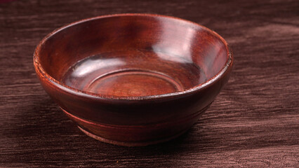 Empty wooden bowl and wooden spoon isolated with copy space.