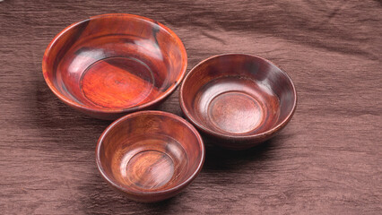 Empty wooden bowl and wooden spoon isolated with copy space.