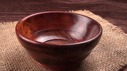 Empty wooden bowl and wooden spoon isolated with copy space.