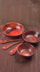 Empty wooden bowl and wooden spoon isolated with copy space.