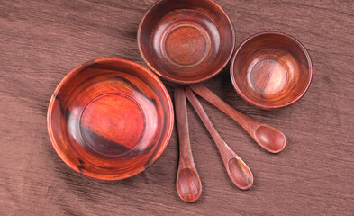 Empty wooden bowl and wooden spoon isolated with copy space.