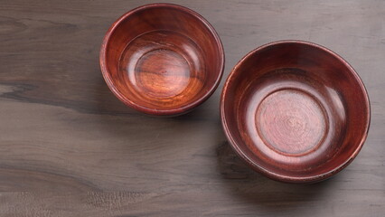  Empty wooden bowl and wooden spoon isolated with copy space.
