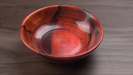 Empty wooden bowl and wooden spoon isolated with copy space.