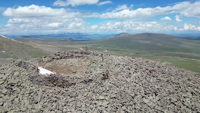 Ruins of a bronze-age fortress on a mountaintop in the Caucasus mountains