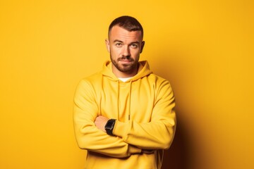 Fototapeta premium Lifestyle portrait photography of a glad boy in his 30s wearing a comfortable tracksuit against a yellow background. With generative AI technology
