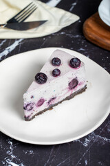 Blueberry cake. Blueberry fruit slice cake on dark background. Close up