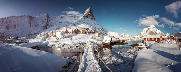Scenic photo of winter fishing village in sunny dat. stunning natural background. Picturesque Scenery of Reinefjord one most popular place of Lofoten islands. Norway. ideal resting place.