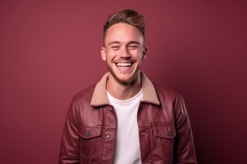 Obraz premium Medium shot portrait photography of a happy boy in his 30s wearing a denim jacket against a burgundy red background. With generative AI technology