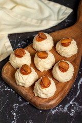 Almond and caramel cookies. Almond cookies on dark background