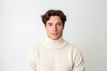 Fototapeta premium Environmental portrait photography of a glad boy in his 30s wearing a classic turtleneck sweater against a pearl white background. With generative AI technology