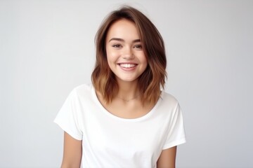 Fototapeta premium Medium shot portrait photography of a glad girl in her 20s wearing a casual t-shirt against a pearl white background. With generative AI technology