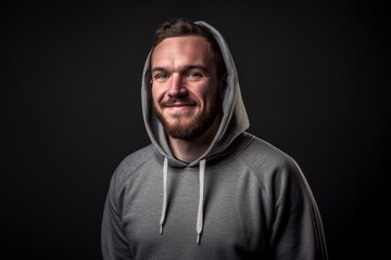 Lifestyle portrait photography of a glad boy in his 30s wearing a comfortable hoodie against a metallic silver background. With generative AI technology