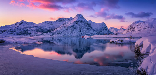 Beautiful winter landscapes in Lofoten islands, Northern Norway. wintry season. Amazing winter nature scenery. Fantastic colorful sunset over north fjord above snow covered mountains. Norway - 623449048