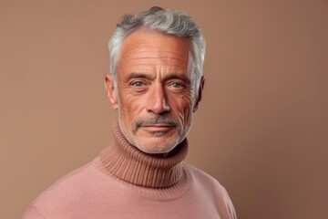 Medium shot portrait photography of a tender mature man wearing a classic turtleneck sweater against a beige background. With generative AI technology