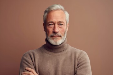 Medium shot portrait photography of a tender mature man wearing a classic turtleneck sweater against a beige background. With generative AI technology