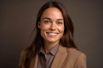 Fototapeta premium Close-up portrait photography of a grinning girl in her 30s wearing a sleek suit against a warm taupe background. With generative AI technology