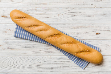 fresh crunchy french baguette on colored table. Top view Bakery products