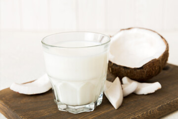 coconut products on white wooden table background. Dairy free milk substitute drink, Flat lay healthy eating