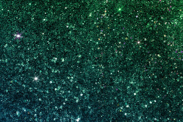 A blue-green diamond background sparkles with stars in the light of holiday lights.