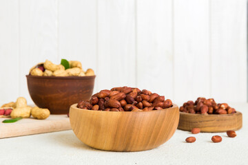 Fresh healthy peanuts in bowl on colored table background. Top view Healthy eating bertholletia concept. Super foods