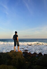 A man enjoy beautiful sunset at Melasti beach.