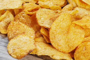 Delicious Barbeque Flavored Potato Chips isolated on a wooden background