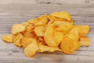 Delicious Barbeque Flavored Potato Chips isolated on a wooden background