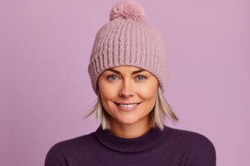 Medium shot portrait photography of a tender mature woman wearing a warm beanie or knit hat against a lilac purple background. With generative AI technology