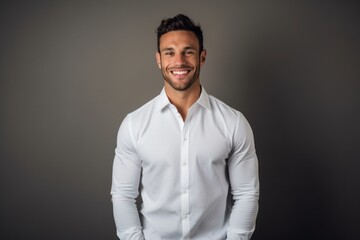 Obraz premium Headshot portrait photography of a happy boy in his 30s wearing an elegant long-sleeve shirt against a minimalist or empty room background. With generative AI technology