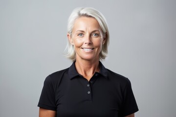 Lifestyle portrait photography of a glad mature woman wearing a sporty polo shirt against a minimalist or empty room background. With generative AI technology