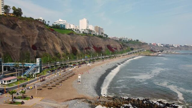 Lima, Peru: Aerial backward drone footage of the Miraflores district by the Pacific ocean in Lima, Peru capital city. 