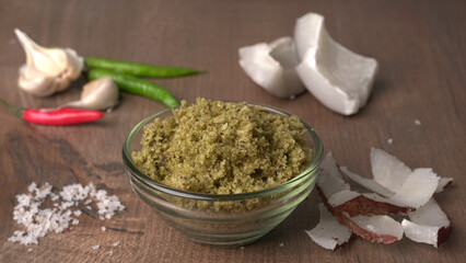 Coconut chutney in a bowl with raw coconut and green chilli ,Served with dosa, idli, vada
