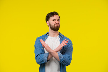 Man showing a x sign with hands and unhappy face expression