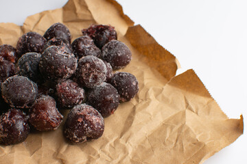 Frozen cherries on a sheet of craft paper