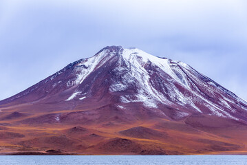 Fototapeta premium Snowy volcanic peak in Atacama desert