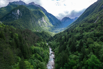 Fototapeta na wymiar Alpine landscape with green forest in Soca valley, Slovenia. Aerial drone view